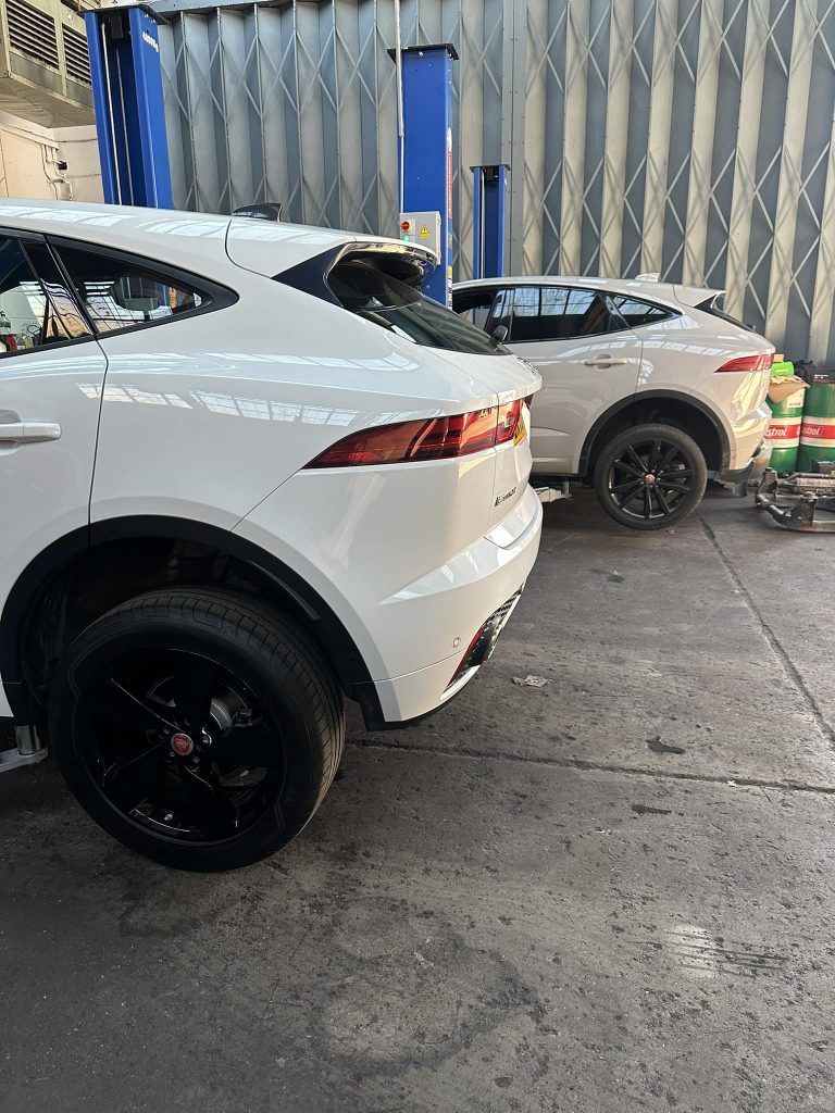 MOT page image: Two Jaguar 4x4s on the jacks in the ASM Independent garage. ASM Independent: Independent Jaguar and Land Rover Specialists Wakefield.